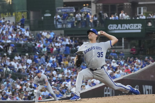 Kansas City Royals starting pitcher Rich Hill throws against the Chicago Cubs during the first inning of a baseball game in Chicago