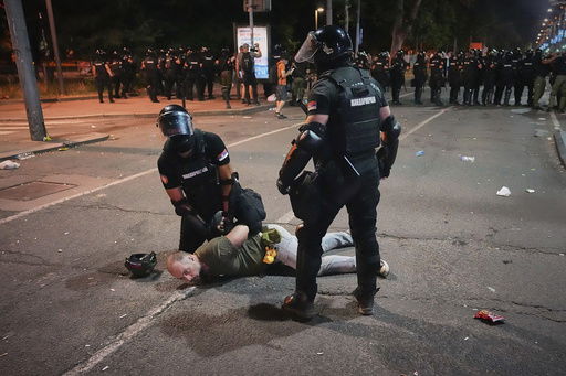 Riot police detain a man after charging protesters at the end of an anti-government rally pressing for an early election after nearly eight months of almost daily anti-corruption demonstrations that have shaken the populist government of President Aleksandar Vucic