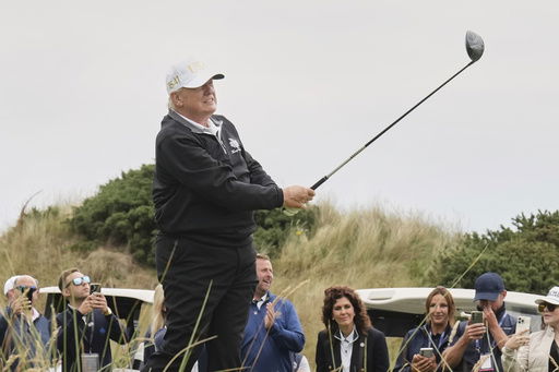 President Donald Trump tees off during the opening ceremony for the Trump International Golf Links golf course