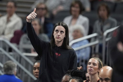 Indiana Fever's Caitlin Clark reacts on the sideline during the first half of a WNBA basketball game against the Las Vegas Aces