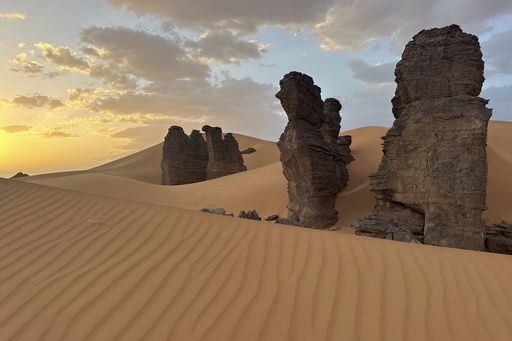 Rock formations stand in the Sahara desert outside the city center of Djanet