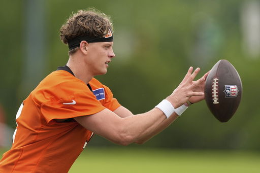 FILE - Cincinnati Bengals quarterback Joe Burrow catches a ball during NFL football practice on Tuesday