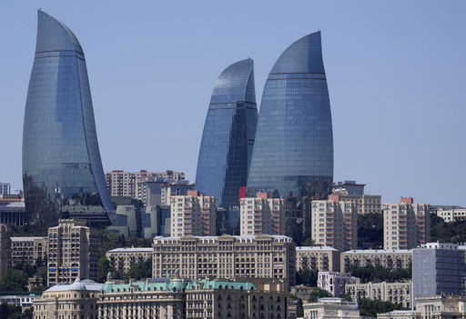 FILE - The Old City stands with the Flame Towers skyscrapers in background in Baku