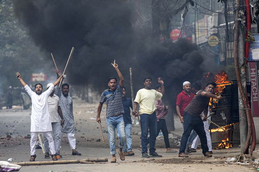 FILE - Students clash with police during a protest over the allocation of government jobs