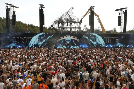 People listen to DJs Odymel and Pegassi performing at the Tomorrowland music festival in Boom