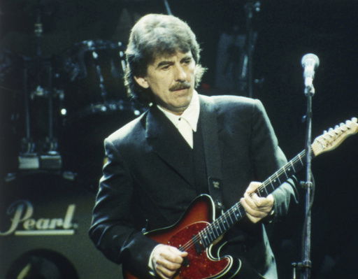 FILE - George Harrison performs at a concert in London on April 6
