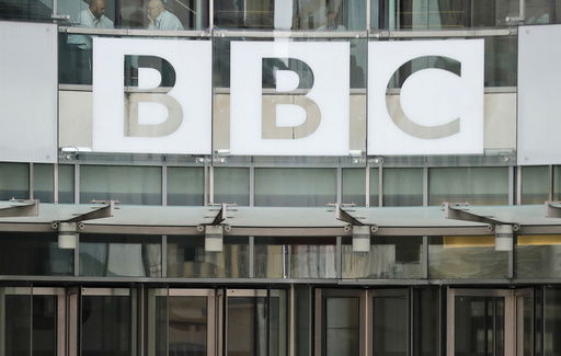 FILE - This photo shows a BBC sign outside the entrance to the headquarters of the publicly funded media organization in London