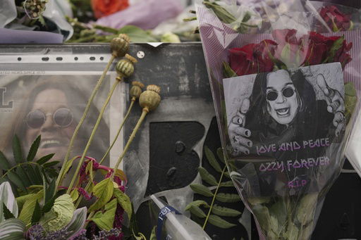 Flowers and messages are left by fans to commemorate the death of Ozzy Osbourne at the Black Sabbath Bridge in Birmingham