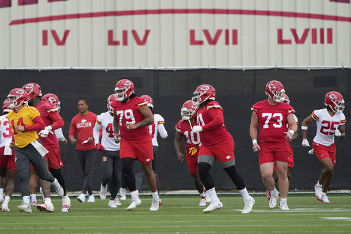 Kansas City Chiefs players warm up before the NFL football team's practice Tuesday