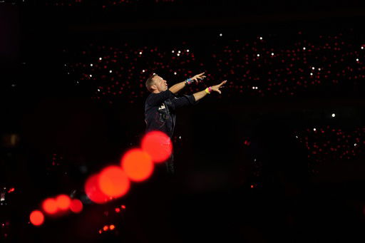 FILE - Chris Martin of Coldplay performs during the band's Music Of The Spheres World Tour at D. Y. Patil Sports Stadium in Navi Mumbai