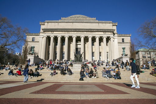FILE - Students sit on the front steps of Low Memorial Library on the Columbia University campus in New York City