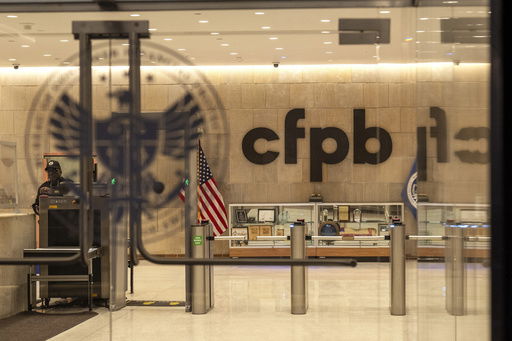 FILE - A security officer works inside of the Consumer Financial Protection Bureau (CFPB) building headquarters