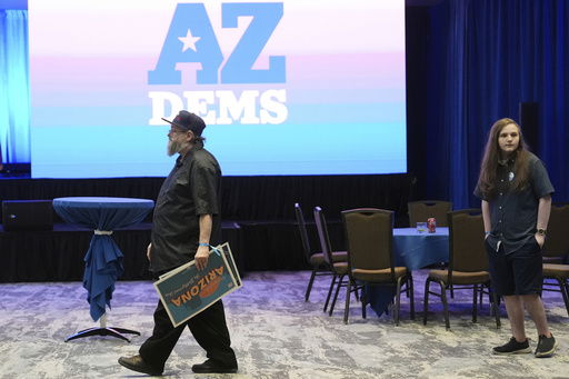 FILE - Arizona Democratic party supporters walk to the exit after attending a watch party on election night Tuesday