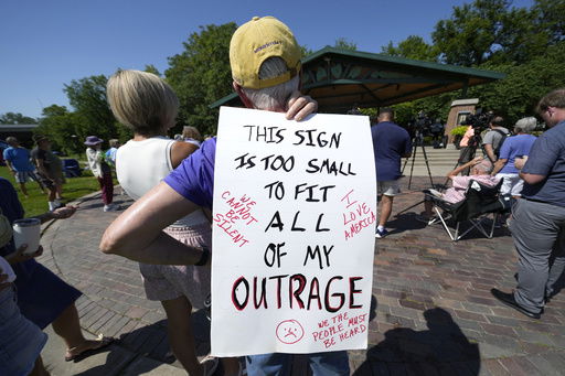 A local resident listen to a speech during an Iowa Democratic Party rally