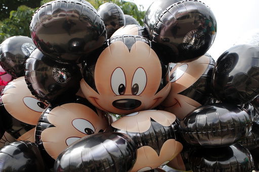 FILE - Mickey Mouse balloons are displayed at Disneyland Paris in Chessy