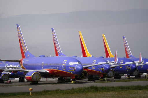 FILE - A line of Southwest Air Boeing 737 jets are parked near the company's production plant while being stored at Paine Field Friday
