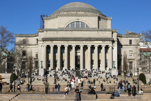 FILE - Students sit on the front steps of Low Memorial Library on the Columbia University campus in New York City