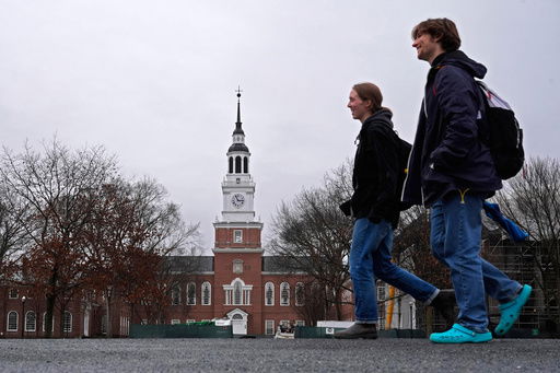 FILE - Students cross the campus of Dartmouth College