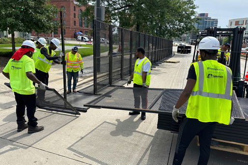FILE - Workers putting up fences near the Republican National Convention location on July 10