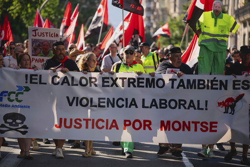FILE - People march in Barcelona to protest the death of street cleaner Montse Aguilar during a recent heat wave in Spain