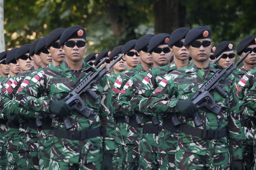 Indonesian troops march during a rehearsal for the upcoming Bastille Day parade