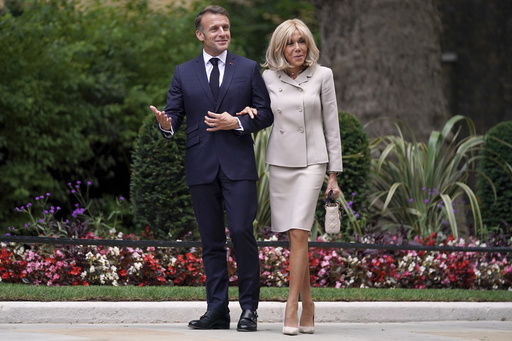 FILE - French President Emmanuel Macron and wife Brigitte arrive at 10 Downing Street in London