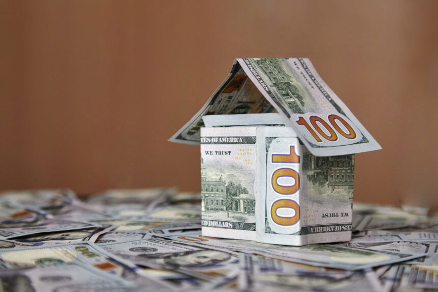 a house of money on the background of money, dollar bills the concept of accumulating investing money