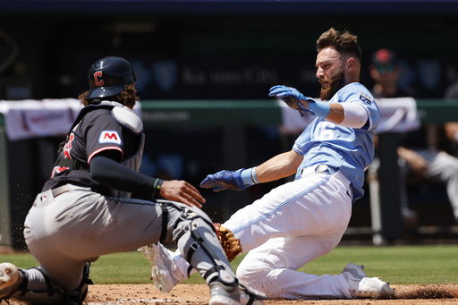 Kansas City Royals' John Rave (16) scores off a Luke Maile double as Cleveland Guardians catcher Bo Naylor