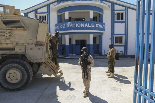 FILE - Haitian and Kenyan police who are part of a UN-backed multinational force stand at a police station in Pont-Sonde