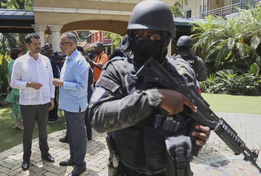 Security guards stand watch as Haiti's Prime Minister Alix Didier Fils-Aime