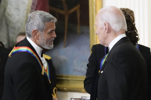 FILE - President Joe Biden shakes hands with actor