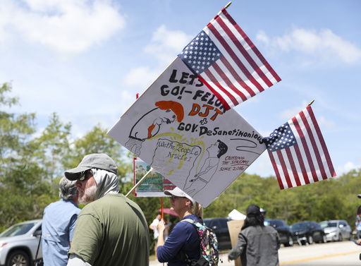 A protester stands outside the migrant detention dubbed 