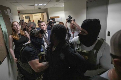 A person is detained by federal agents outside an immigration court at the Jacob K. Javits federal building on Thursday