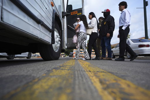 A family from Colombia is detained and escorted to a bus by federal agents following an appearance at immigration court Monday