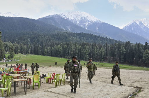 FILE - Indian security officers inspect the site where militants indiscriminately opened fired on tourists the previous day