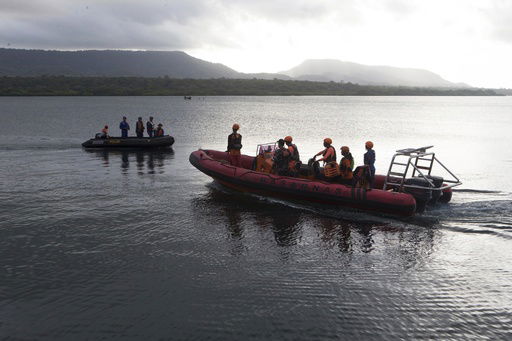 Rescuers search for victims after a ferry sank in the waters off Jembrana