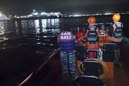 In this photo released by the Indonesian National Search and Rescue Agency (BASARNAS) rescuers search for victims after a ferry enroute for the resort island of Bali sank off Ketapang