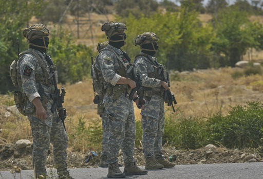 Forces of the regional Kurdish administration patrol the area ahead of a symbolic disarmament ceremony by the separatist PKK group as part of the peace process with Turkey