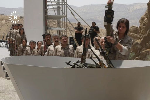 This frame grab from a video released by Rudy TV shows PPK (Kurdistan Workers' Party) fighters during a symbolic disarmament ceremony as part of the peace process with Turkey