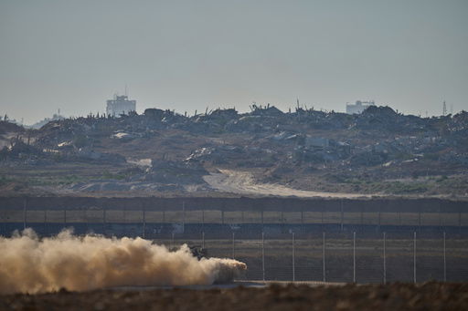 An Israeli army APC moves along the border of the gaza strip in southern Israel