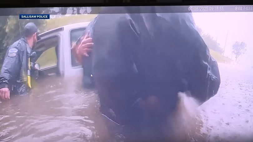 <i>Sallisaw Police/KHBS/KHOG via CNN Newsource</i><br/>Bodycam video showed the rescue of a driver from a nearly submerged truck under a railroad bridge in Sallisaw.