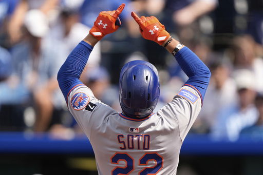 New York Mets' Juan Soto celebrates as he crosses the plate after hitting a two-run home run during the fourth inning of a baseball game against the Kansas City Royals