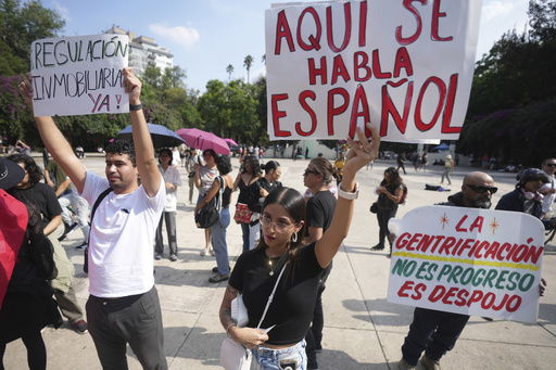 Demonstrators hold posters that read in Spanish ¨Here we speak Spanish