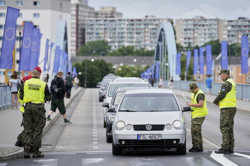Polish border police check vehicles at a checkpoint bordering Germany