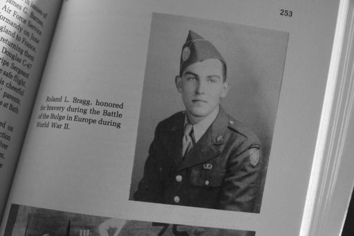 FILE - A military photo of Pfc. Roland L. Bragg is seen in a book about the history of Nobleboro