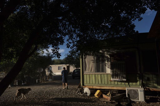 Virgilio Galarza Rodriguez works outside his mobile home in Oasis