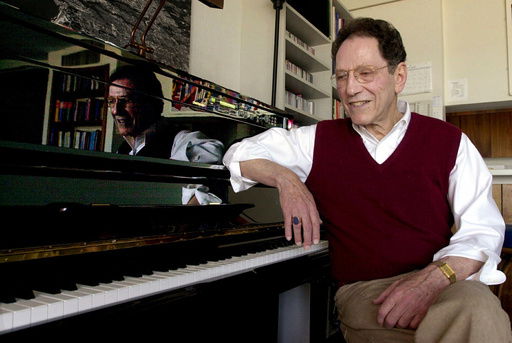 FILE - Musician Tom Lehrer sits beside the piano in his house in Santa Cruz