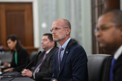 FILE - Brendan Carr listens during a Senate Commerce