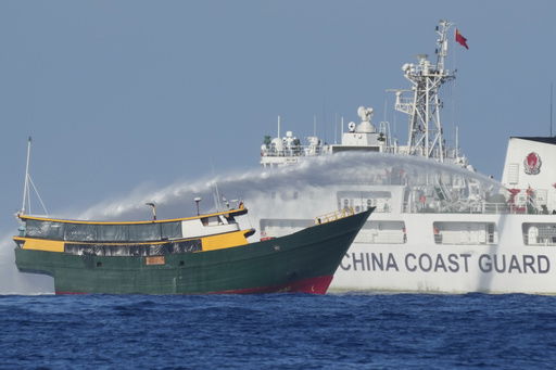 FILE - Philippine resupply vessel Unaizah May 4 is hit by Chinese coast guard water canon blast causing injuries to multiple crew members as they tried to enter the Second Thomas Shoal