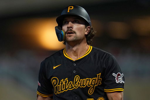 Pittsburgh Pirates' Adam Frazier walks back to the dugout after striking out during the ninth inning of a baseball game against the Minnesota Twins